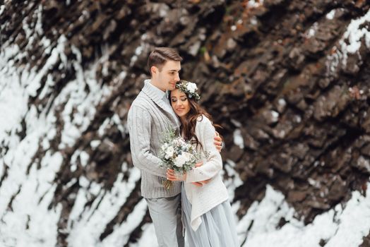 bride and groom on the background of a mountain waterfall