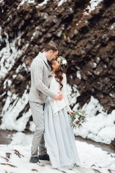 bride and groom on the background of a mountain waterfall