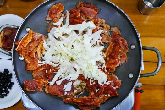 Pork Calbi, meat and vegetable on the pan, tradition of Korean food.