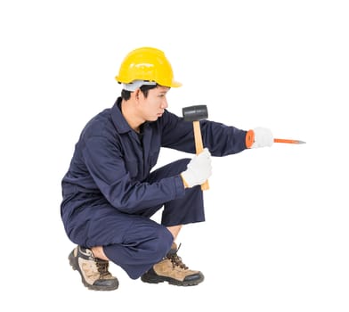 Young man in uniform sit and holding hammer was nailed to a cold chisel, Cut out isolated on white background