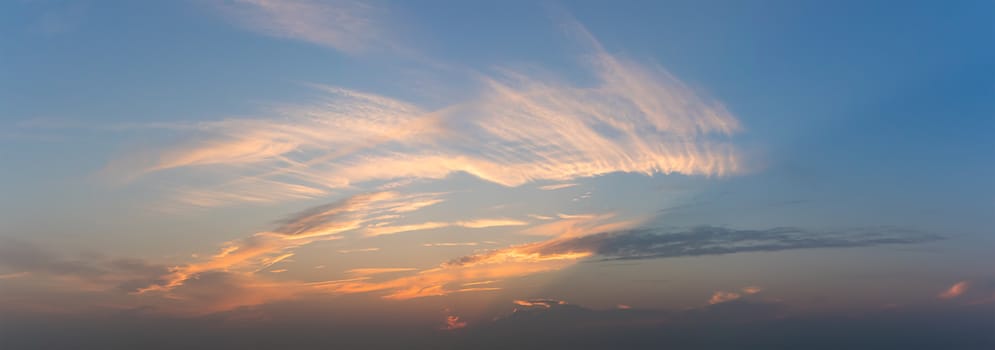 Panoramic blue sky fluffy clouds in the twighligth sky