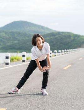 Fitness and lifestyle concept - Young asian woman short hair doing exercising outdoor