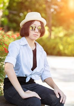 Beautiful and young women with short hair wearing hat in park