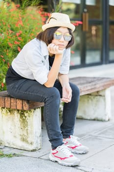 Beautiful and young women with short hair wearing hat in park