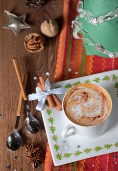 Cup of coffee and Christmas decorations on wooden table