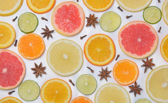 Background with citrus fruit slices, anise star and Clove