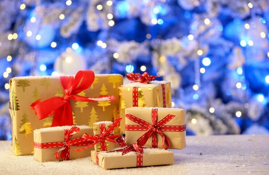 Christmas gifts on table and led  lights in  background