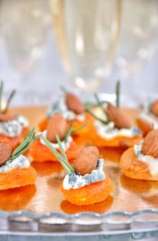 Cocktail snack from dried apricots with gorgonzola and almonds