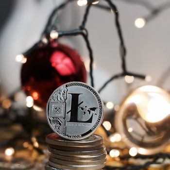 Digital currency physical silver metal litecoin coin. Christmas concept.