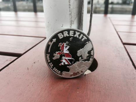 Europe leaving. Article 50. Silver brexit coin with british map. Outdoor concept.