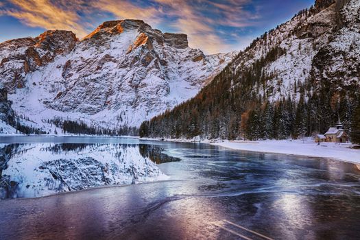 winter sunrise with colorful cloudscape over Lago di Braies, Dolomites, Italy