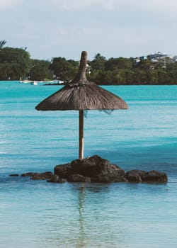 A sun umbrella in the middle of the water near the coast of the Indian Ocean, Mauritius