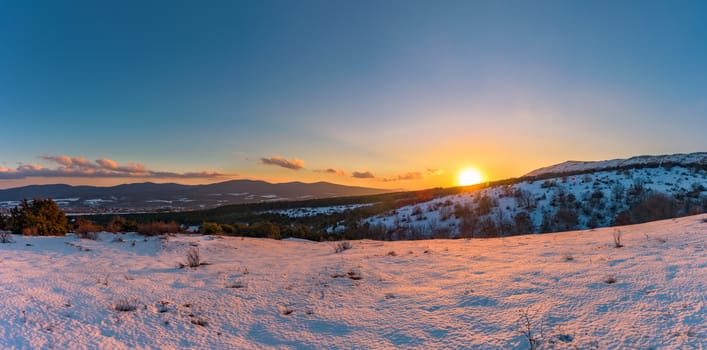 Panoramic beautiful warm orange sunset view from mountain