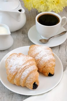 Croissants with chocolate filling cup and fresh morning coffee. 