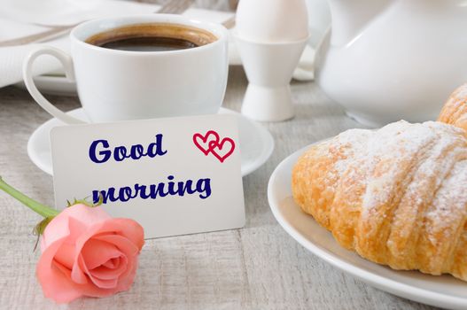 Breakfast of croissants   chocolate filling cup of fresh morning coffee and a card with a wish Good morning.