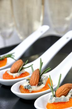 Cocktail snack from dried apricots with gorgonzola and almonds