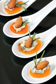 Cocktail snack from dried apricots with gorgonzola and almonds