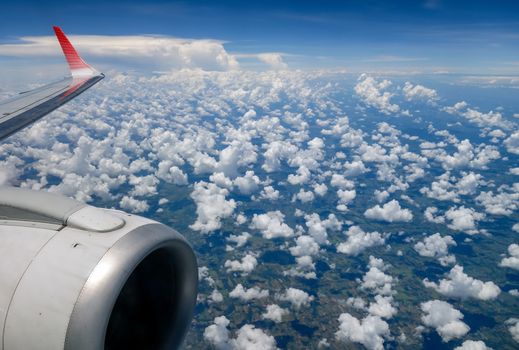 cloudscape sky and airplane wings view from window