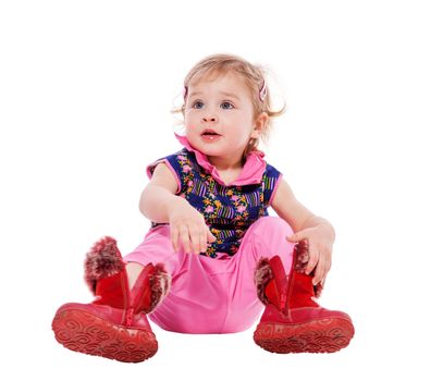 Baby putting on shoes sitting  isolated on white