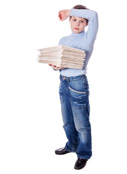 Serious upset schoolboy holding lots of papers isolated on white