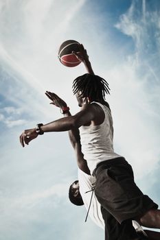 Two African American Playing basketball