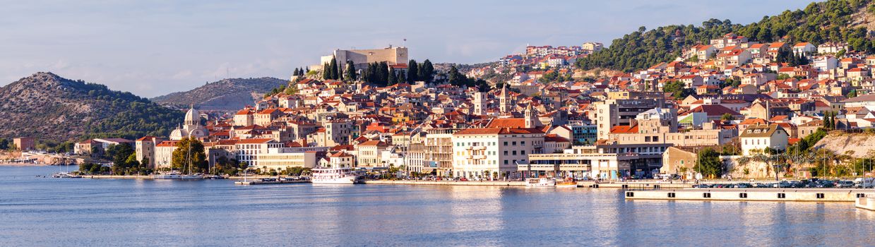 Large panorama of Unesco heritage historic town of Sibenik on Adriatic sea, Dalmatia, Croatia. Shot from the sea, harbor, waterfront and cathedral in front and ancient fort overlooking the town on hill top, XXL Panorama