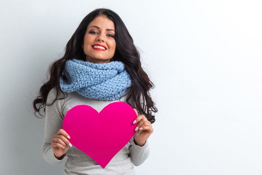 Valentines Day. Woman holding Valentines Day paper heart with copy space