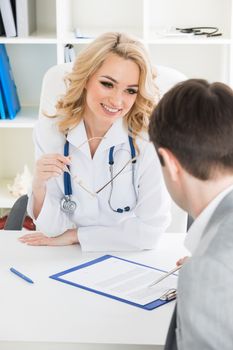 Doctor consulting patient in a clinical office