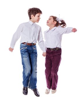 brother and sister jumping together isolated on white