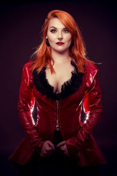 attractive girl orange hair in red latex jacket