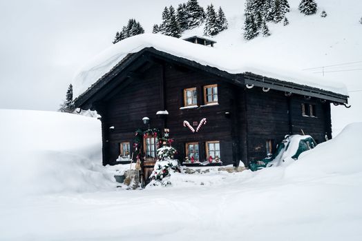 Chalet covered with snow and decorated with Christmas objects