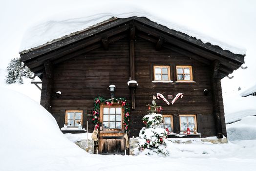 Chalet covered with snow and decorated for Christmas