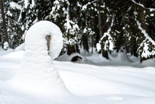 Snowdrift on a post in the mountain in winter