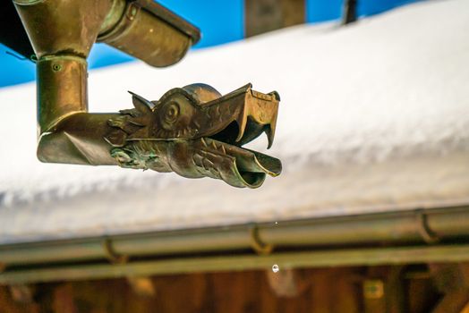 Fancy gutter dripping snow droplets in the winter