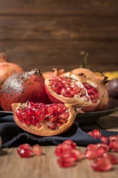 Pomegranate fruit on rustic table in vintage style.