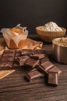 Homemade muffins with chocolate and baking ingredients.