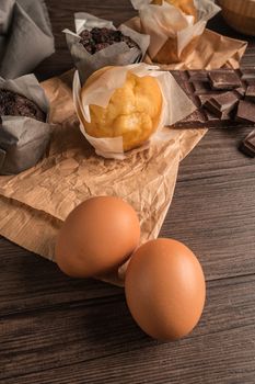 Homemade muffins with chocolate and baking ingredients.