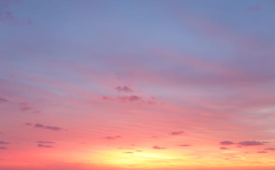 Morning sunrise skies with colours of yellows, rich reds and blues in the sky above with some light cloud