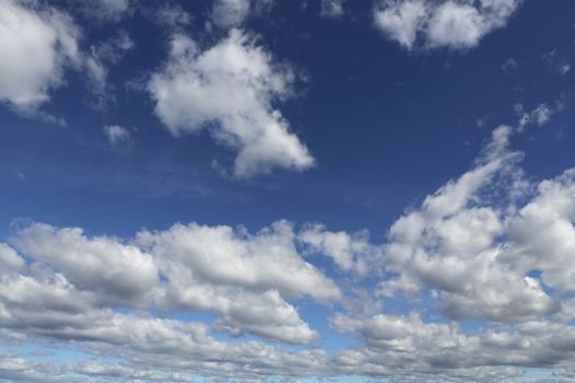 Blue skies with white fluffy clouds