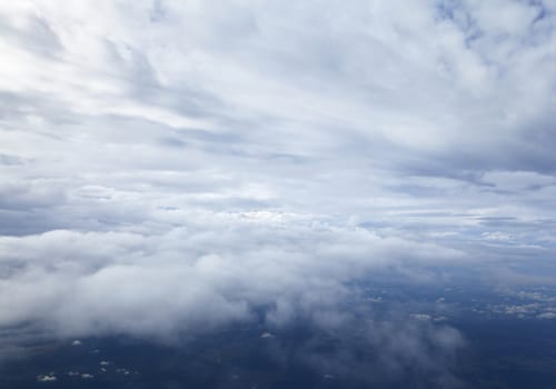 Blue and silver clouds background, view from airplane