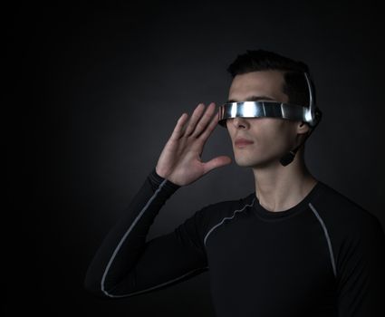 Man using futuristic VR goggles headset with microphone