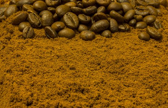 Background with coffee beans and ground coffee