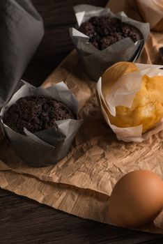 Homemade muffins with chocolate and baking ingredients.