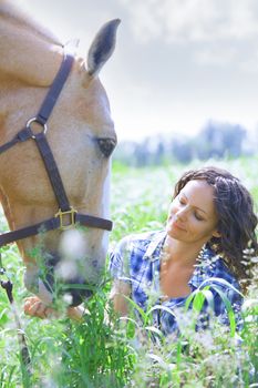 Woman and horse together at paddock