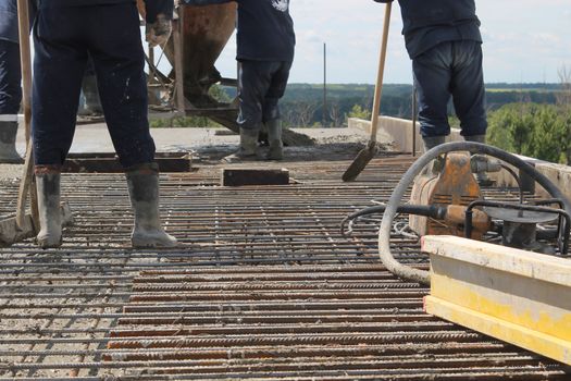 workers at the construction site poured concrete floor.