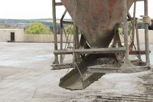 workers at the construction site poured concrete floor.