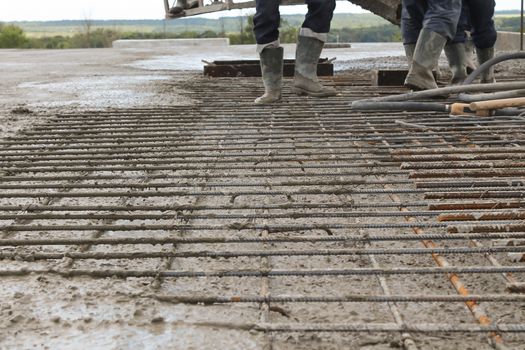 workers at the construction site poured concrete floor.