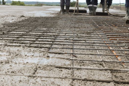 workers at the construction site poured concrete floor.