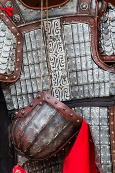 Close up of a rusting ancient asian suit of armour.