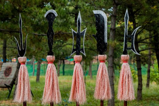 Close up of ancient asian weapons displayed on a weapons rack in the training field.